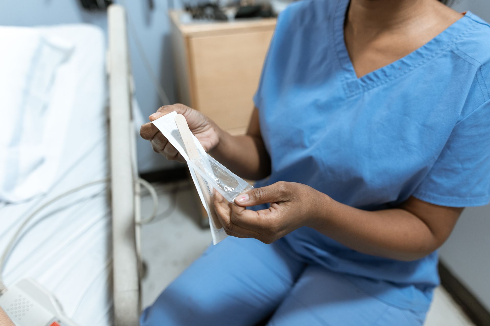 A theatre nurse opening a sterile instrument pack